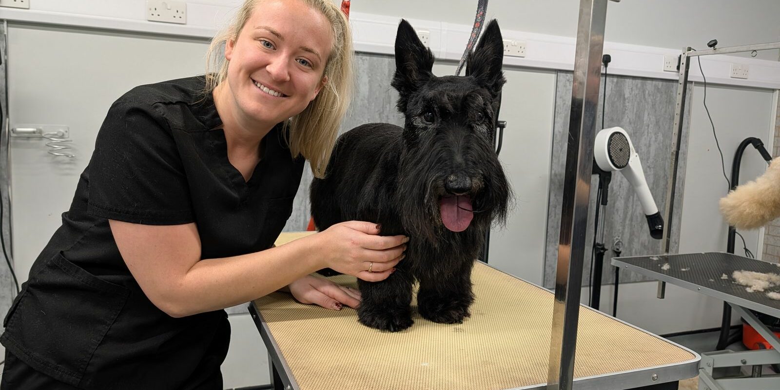 Kelsie from Snip Doggy Dogg with a happy customer